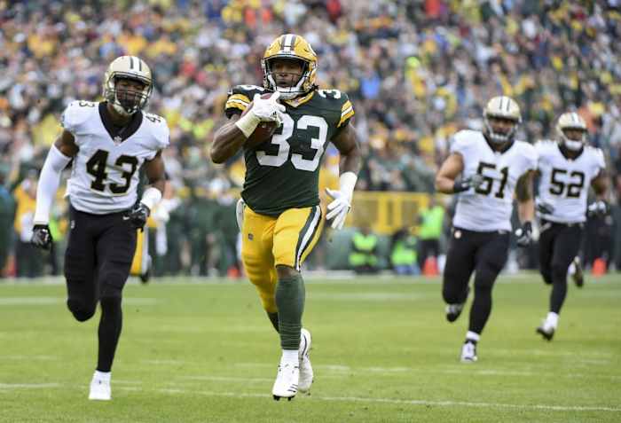 Green Bay Packers running back Aaron Jones (33) runs past the New Orleans Saints for a touchdown. Mandatory Credit: Benny Sieu-USA TODAY
